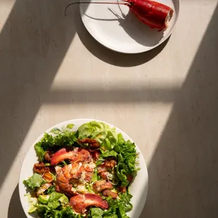 a plate of salad and a plate of shrimp