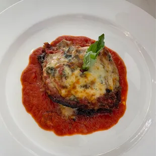 a plate of lasagna and sauce