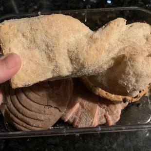 a hand holding a piece of bread