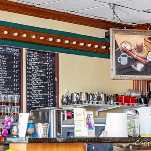 a woman behind the counter of a coffee shop