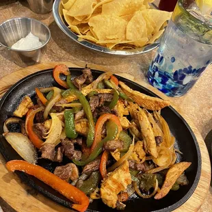 Fajita Chicken and fajita beef mix ($16) with my side of sour cream ($1.75)