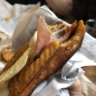 Monte cristo breakfast sandwich! French toast, ham, cheese, fried egg, grilled onions. With jam!