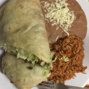 Burrito amigo de asada con arroz y frijoles refritos.