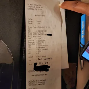 a receipt with a picture of a person holding a cell phone