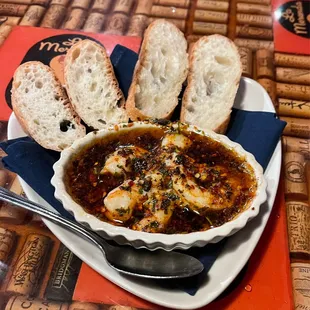Shrimp in hot garlic oil with bread to dip in