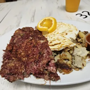 Cornbeef hash,fried eggs and potatoes with Freshed squeezed OJ