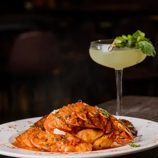 a plate of pasta and a cocktail