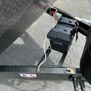 A single battery and the grounding wires installed and exposed to the elements.