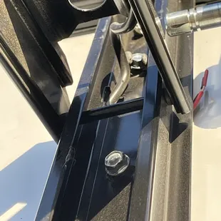 The 2 bolts holding the left or rear side of the awning arm hardware onto the trailer.
