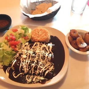 Chicken enchiladas mole with a side of plantains. Delicious!