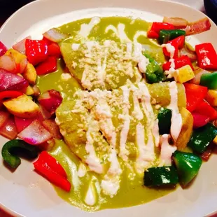Enchiladas Vegetariana in a creamy pumpkin seed sauce.