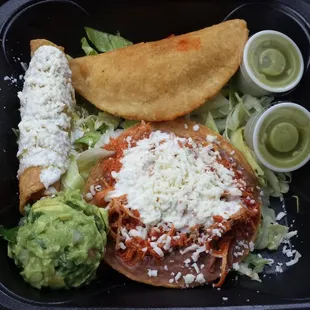 Mexican platter with tostada, flauta, and empanada