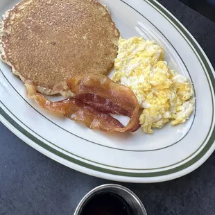 a breakfast of pancakes, eggs and bacon