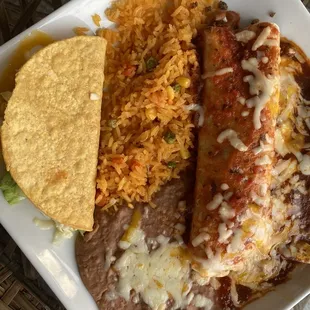 Combo plate of cheese enchilada, beef taco and beef burrito with rice and refried beans.