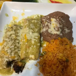 Pork and Chicken Tamales with Refried Beans and Rice.