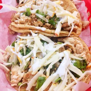 Chicken tacos with cilantro, onion and cheese
