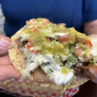 a hand holding a taco