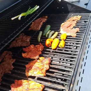 The red marinated chicken in front and the best asada in the IE in the back, veggies are only for garnish