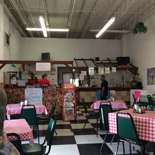 a checkered floor with tables and chairs