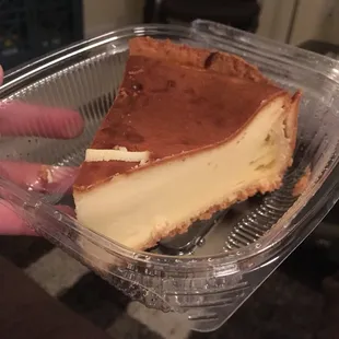 a slice of cheesecake in a plastic container