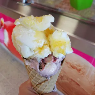 Cone with two big scoops-- Gansito (chocolate twinkie flavor) on bottom and pina colada on top. All for $3
