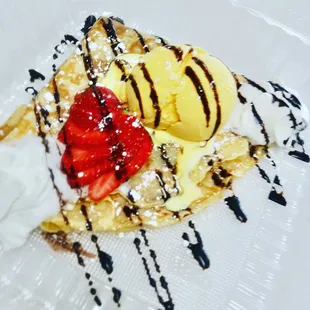 a waffle topped with strawberries and ice cream