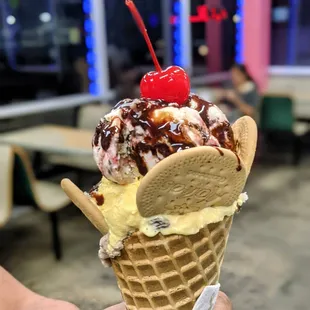 an ice cream cone with a cherry on top