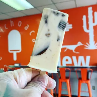 a hand holding a piece of ice cream