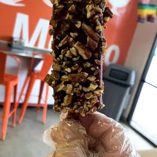 a hand holding a donut