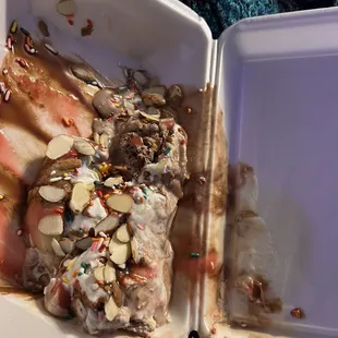 a partially eaten ice cream sundae in a styrofoam container