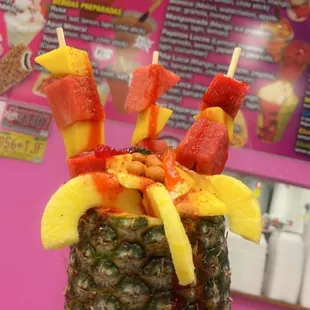 a pineapple with fruit on top