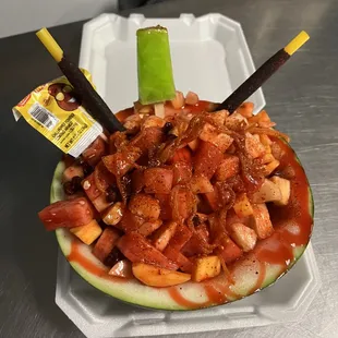 a watermelon filled with meat and vegetables