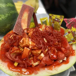 a watermelon with a knife sticking out of it