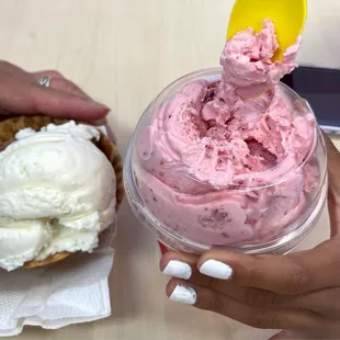 a hand holding a cup of ice cream