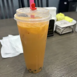 a plastic cup with a straw and a cherry on top