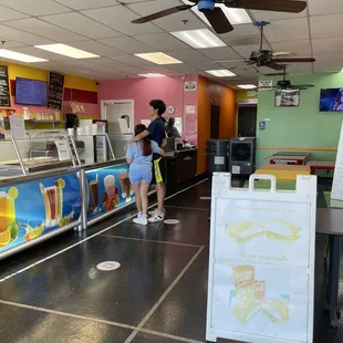 a woman and a man standing in front of the counter