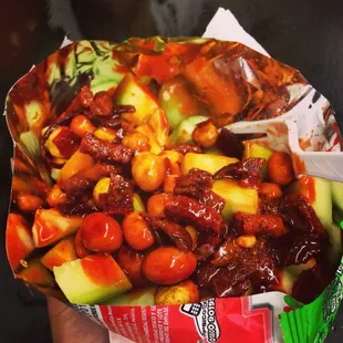 a hand holding a bag of food