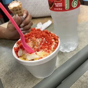 Elote  :Corn with Hot Cheetos served in a cup with Butter, Chile, Mayo and Cheese