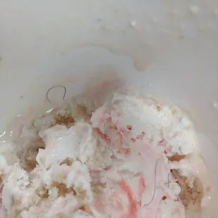 Strawberry with cream and hairs.