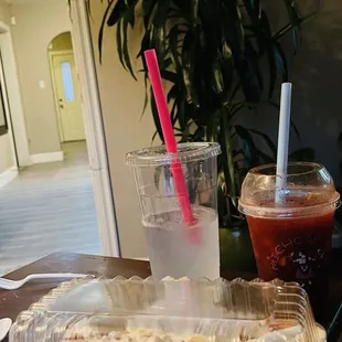 a plastic container of ice cream and a plastic container of iced coffee