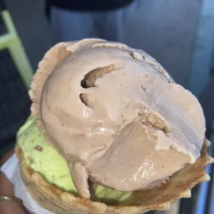 a hand holding an ice cream cone