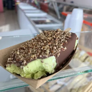Pistachio dipped in milk chocolate with pecans topping