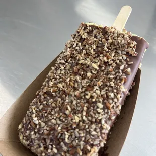 Pistachio dipped in milk chocolate with pecans topping