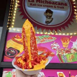 a hand holding a plate of food