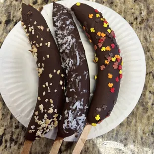 three chocolate covered bananas
