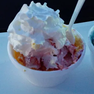 Mango/coconut and blackberry cheesecake with whipped cream.