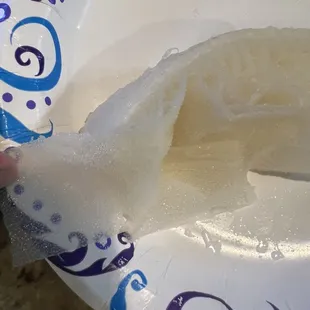 a person holding a piece of fish