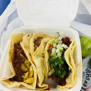 three tacos in a styrofoam container