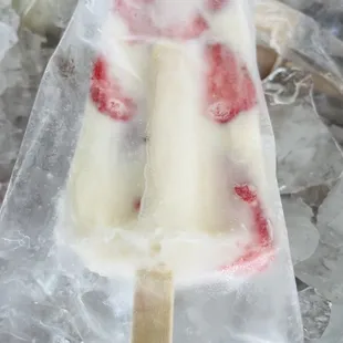 a close up of a popsicle covered in ice