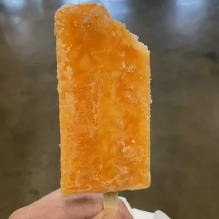 a hand holding a piece of ice cream